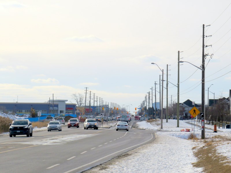 Steeles Avenue, looking west towards Eastvale Drive and the signalized intersection beyond, at Tapscott Road